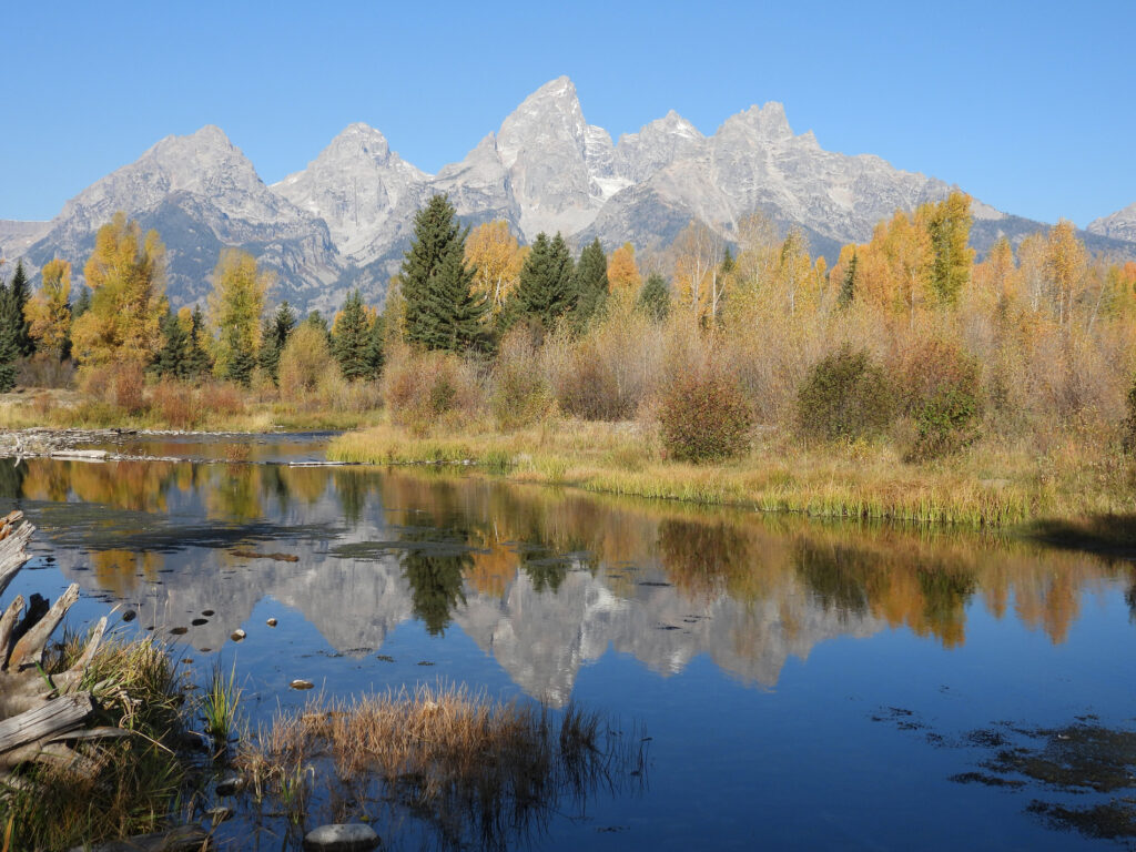 snowcapped mountains reflected in calm alpine lake