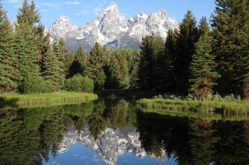 Grand Teton mountains reflected in calm river landscape