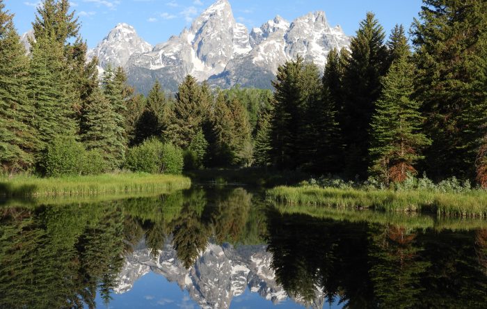 Grand Teton mountains reflected in calm river landscape