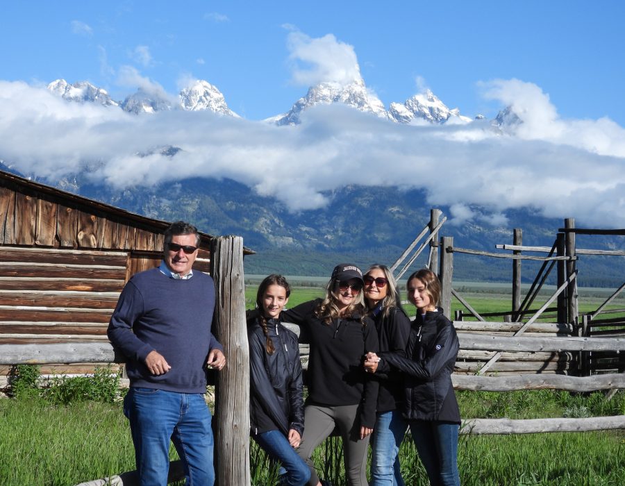 group of visitors standing beside snow covered mountain landscape